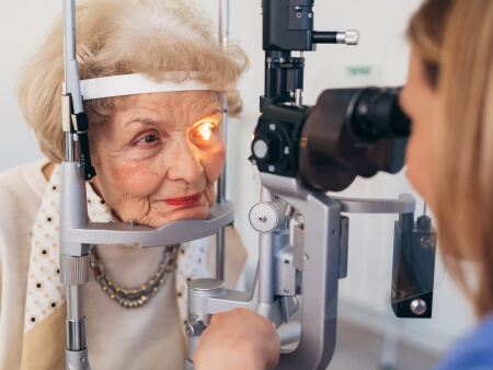 senior checking eyes